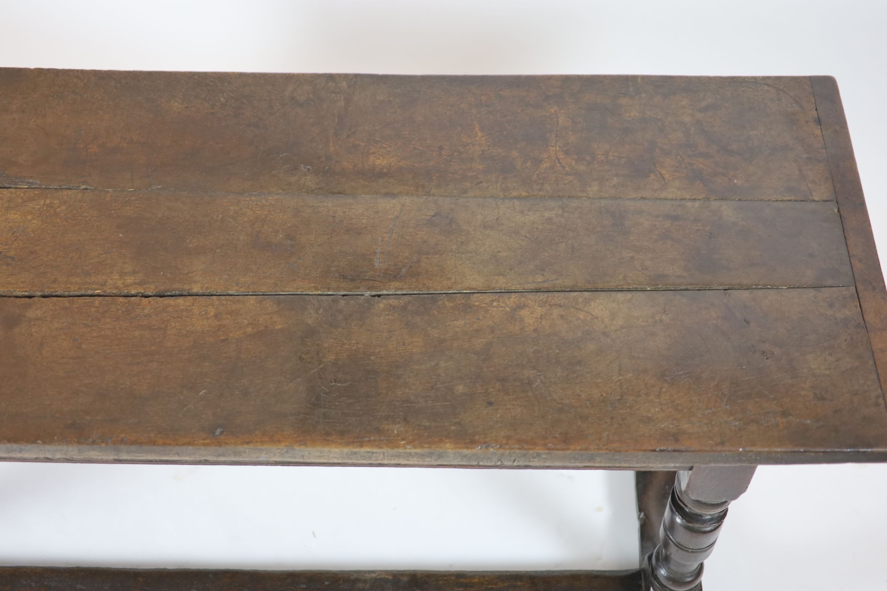 A Charles I oak refectory table, possibly West Country, having three-plank top H 74cm. W 220cm. D 76cm.